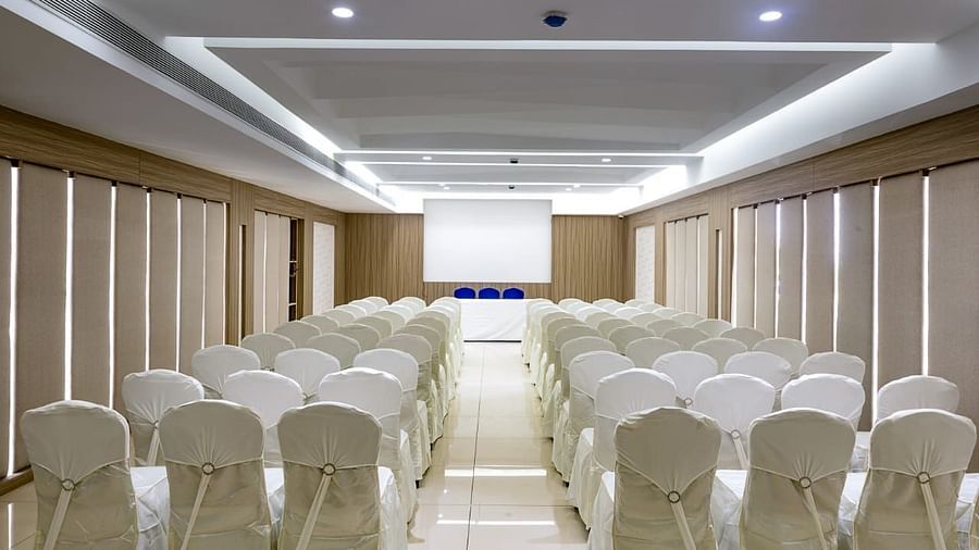 V Square Hall at Mayberry Tiruppur viewed from the back, featuring all chairs arranged neatly